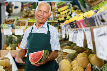 Owner of greengrocery offering fruits and vegetables
