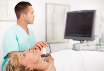 Doctor using ultrasound scan examining patient in hospital