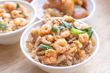 Braised shrimp over rice - Taiwan famous traditional street food. Soy-stewed prawn on cooked rice. Travel concept, top view, copy space, close up