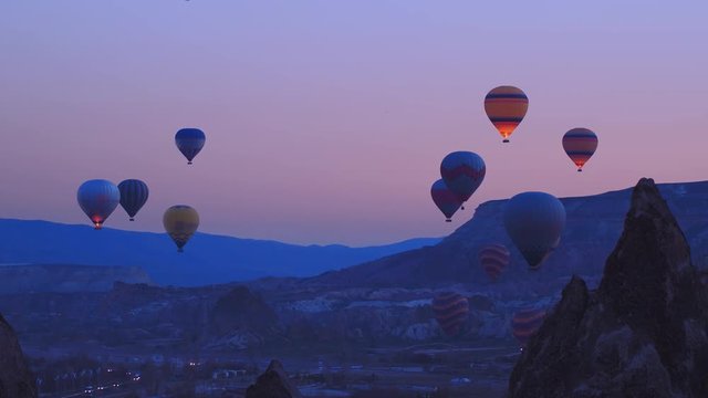Hot air baloons preparing for take off. Famous sightseeing Cappadocia. Lights of air balloons.