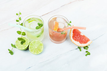 Glasses of lemonade with sliced fruit