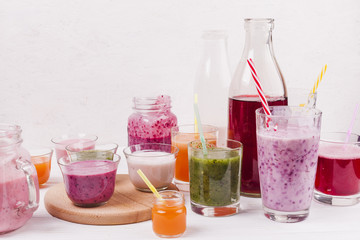 Assortment of colorful smoothies on table