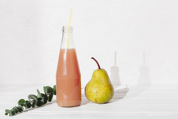 Bottle of juice with pear and leaves