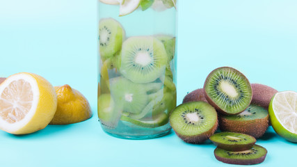 Fototapeta na wymiar Bottle of drink with kiwi and lemon