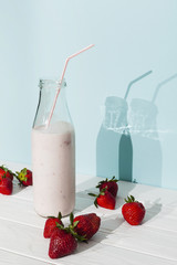 Strawberry pink smoothie in glass bottle