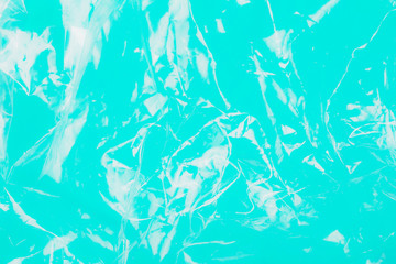 Fototapeta na wymiar Abstract plastic texture on teal background as symbol of a major environmental problem. Ecology concept.