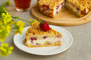 Pie with berries. Sweet homemade cake stuffed with cream cheese and strawberries. Closeup, rustic style.