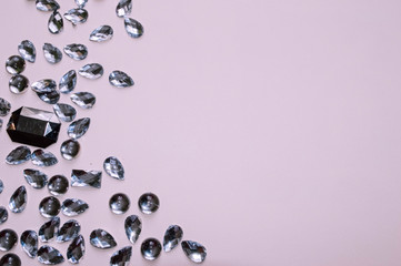 Fake jewelry stones on pink background. Jeweler concept
