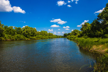 Beautiful scenery. River with trees on the banks. Blue sky with white clouds. Russia. Mordovia.