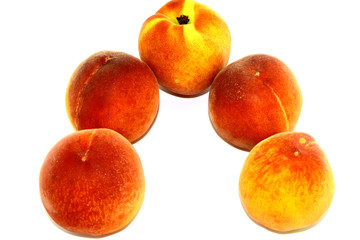 Five juicy peaches on white background