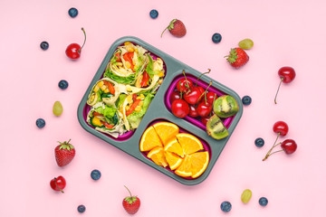 School lunch box with tasty food on color background