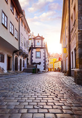Obraz na płótnie Canvas Czech Krumlov Czech Republic. Paved paving stones old street. Touristic landmark in travel. Evening sunset landscape.