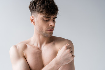 Naklejka premium serious shirtless sexy muscular man isolated on grey