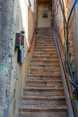 Fototapeta na wymiar Old staircase with peeling walls