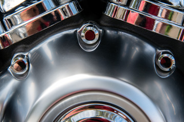 Close-up image of a motor cycle engines crank case with a combination of chrome brushed steal and...