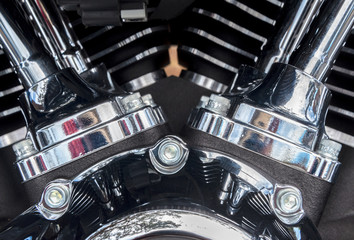 Close-up image of a motor cycle engine of with chrome brushed steal and black metal