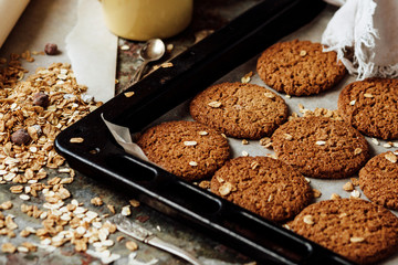 Oatmeal cookies and ingredients and coffee in rustic style