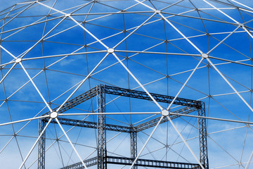Fototapeta premium Sphere construction metal carcass and blue sky with white clouds.
