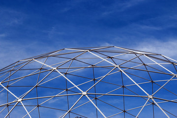 Metal constructions and blue sky with white clouds