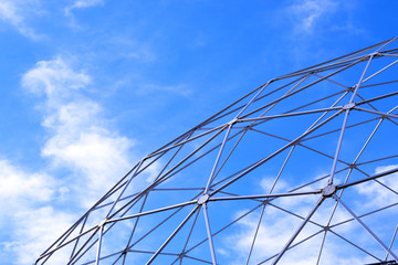 Fototapeta premium Metal constructions and blue sky with white clouds