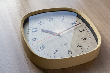 wooden plastic  clock on wooden wall. concept : time is value.
