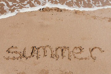Fototapeta premium Summer (inscription) on the beach (sand) by the sea or ocean. Summer mood concept.