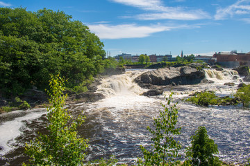 Side view of Lewiston Falls and the city skyline