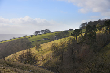 Views out over farmland and farm buildings near Horton in Ribblesdale, Yorkshire Dales.