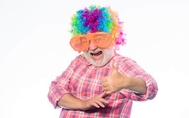 Elderly clown. Having fun. Funny lifestyle. Fun and entertainment. Comic grandfather concept. Nice joke. Grandpa always fun. Man senior bearded cheerful person wear colorful wig and sunglasses