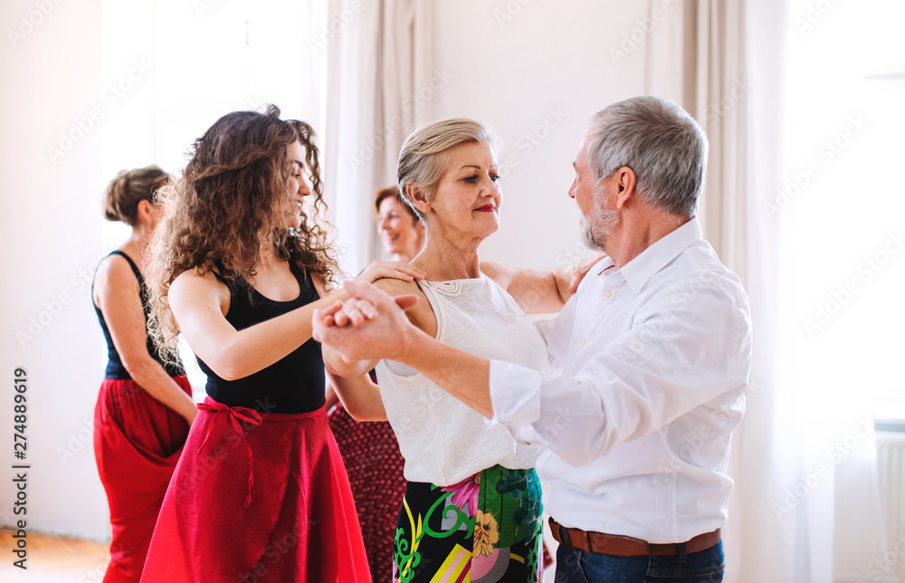 Wall mural group of senior people in dancing class with dance teacher. - Wall murals