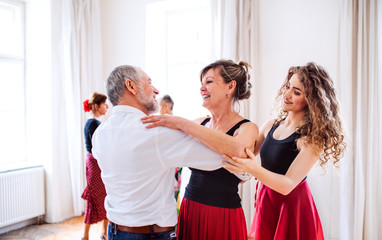 Group of senior people in dancing class with dance teacher.
