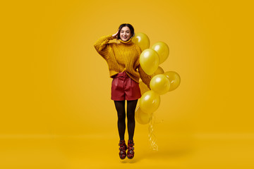 Weird female with balloons jumping and saluting