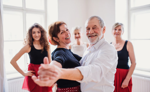 Group of senior people in dancing class with dance teacher.