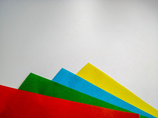 multicolored sheets of paper on a white background