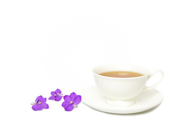 Tea in white cup with purple orchid isolated on white background.