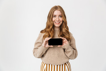 Attractive young girl wearing sweater standing isolated