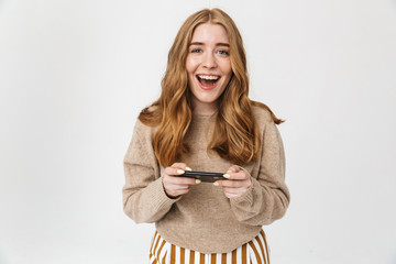 Fototapeta premium Attractive young girl wearing sweater standing isolated