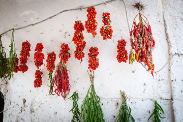 Typical old town house with peppers and tomato hung out to dry. Spinazzola, Apulia region, Italy