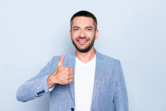 Close up photo amazing he him his guy macho reliable person hands arms  thumb up symbol advising new methodical book white teeth peaceful kind wear  formal-wear jacket blazer isolated grey background Stock