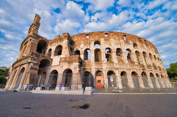 Naklejka premium ROME, ITALY - JUNE 2014: Tourists visit Colosseum. The city attracts 15 million people annually