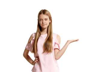 Fototapeta premium Studio portrait of a beautiful girl blonde teenager in a pink t-shirt posing isolated on white background.