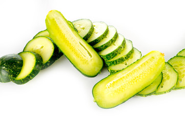 Fresh bright green cucumber slices on a white background