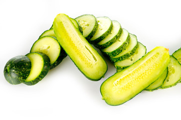 Fresh bright green cucumber slices on a white background