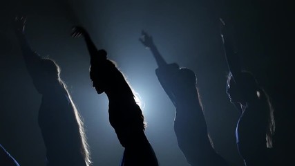 Close-up. Slow motion of silhouettes dancing women
