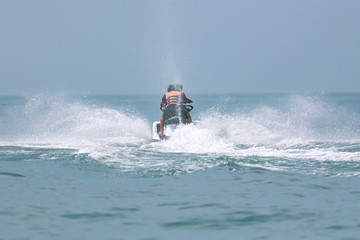 Jet ski at speed in a spray of water