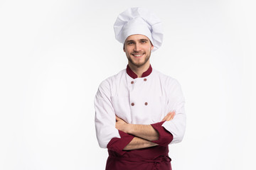 Portrait of positive handsome chef cook in beret and white outfit isolated on white background.