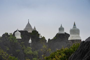 Fototapeta na wymiar Chaloem Phra Kiat Temple, Pagoda on the mountain in the mist,Thailand