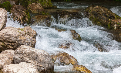 Water runs over rocks in the mountains