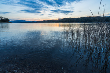 Wide-angle lake in the morning, sunrise after the mountain