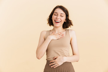 Obraz premium Portrait of cheerful happy woman 20s dressed in casual clothes having fun and burst out laughing